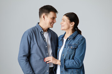 Studio shot of beautiful senior couple posing against a grey background  in casual clothes isolated over grey background