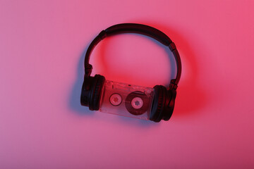 Stereo headphones with audio cassette in red blue neon light