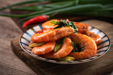 Delicious pan-fried shrimp on dark wooden table background.