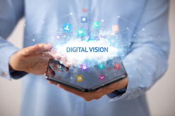 Businessman holding a foldable smartphone with DIGITAL VISION inscription, technology concept