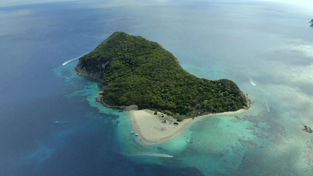 smooth drone shot of the whole island of marathonisi, (turtle island) in Zakynthos, Greece