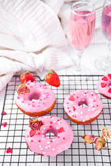 Pink doughnuts on the baking rack. Valentine's Day concept.
