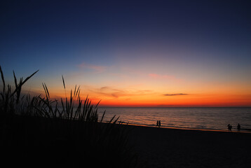Obraz premium Romantic sunset over the Baltic Sea, orange vivid colors, beautiful sky, Krynica Morska