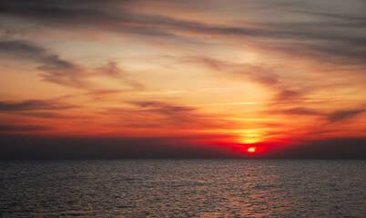 Romantic sunset over the Baltic Sea, orange vivid colors, beautiful sky, Krynica Morska