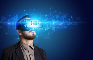 Businessman looking through Virtual Reality glasses with INTERNET SECURITY inscription, cyber security concept