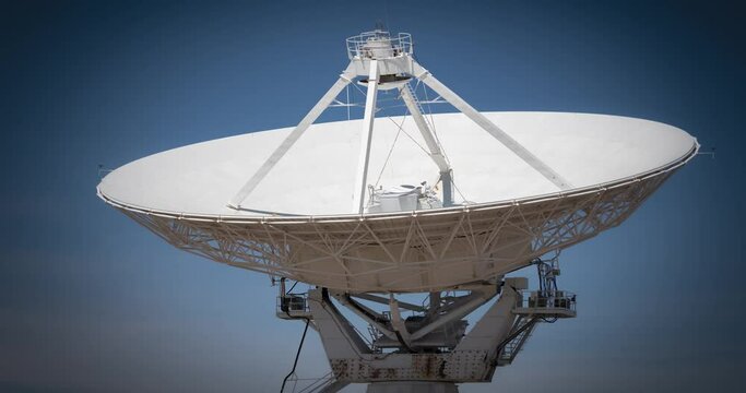 A satellite dish that is part of the Very Large Array in New Mexico adjusts over time to track objects in space.