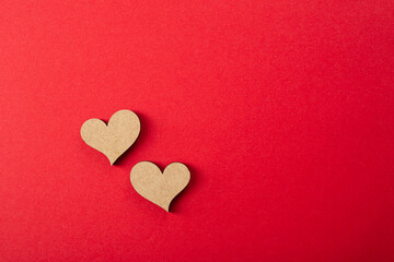 Obraz premium Two wooden heart on red surface, flat lay