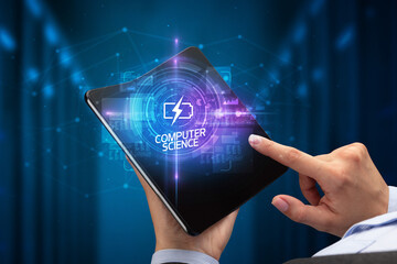 Businessman holding a foldable smartphone with ENERGY inscription, new technology concept COMPUTER SCIENCE
