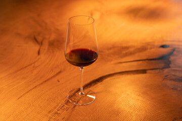 Glass of red wine on a wooden table
