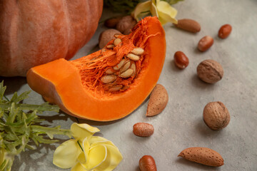 crushed walnuts, shelled walnuts, pumpkin and yellow flowers (selective focused)