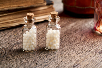 Bottles with homeopathic remedies on a wooden table