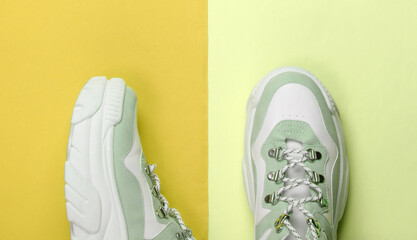 Fashionable sneakers with high soles (platform) on colored background. Top view. Minimalism
