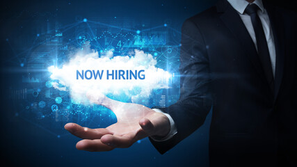Hand of Businessman holding NOW HIRING inscription, successful business concept