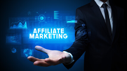 Hand of Businessman holding AFFILIATE MARKETING inscription, business success concept