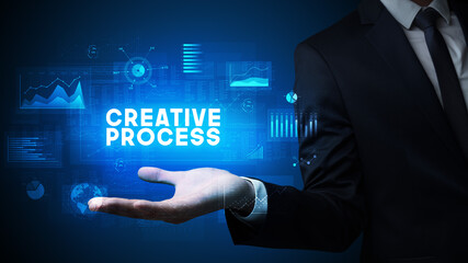 Hand of Businessman holding CREATIVE PROCESS inscription, business success concept
