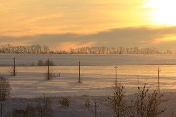 Sunrise over the snow covered field