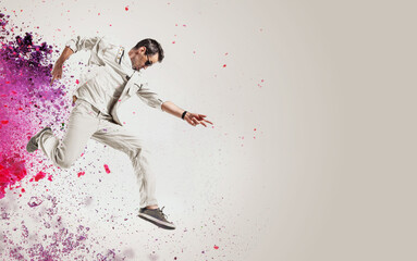 Talented dancer jumping out of paint splash