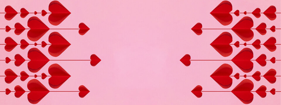 Valentine's Day love wedding background banner panorama greeting card template - Red hanging hearts isolated on pink paper texture