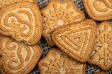 Delicious homemade cookies on a wooden table on a homespun fabric with a rough texture. Close-up selective focus.