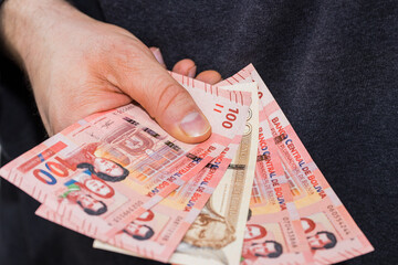 Bolivian banknotes. Money spread out and held in the hand