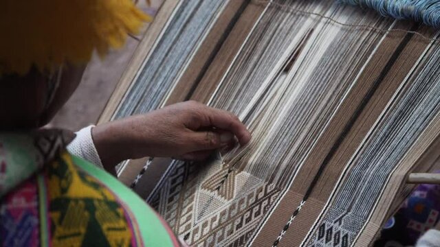 A peruvian artisan weaving traditional pattern