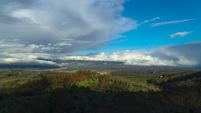 Time Lapse of clouds moving revealing a rainbow at the end. Took in front of the Pratomagno mountains in Valdarno, Tuscany, Italy