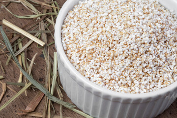 Amaranth in white bowl isolated on wooden background