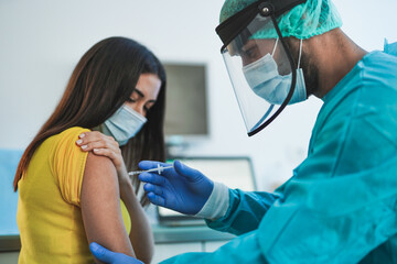 Male doctor or nurse vaccine to a patient's shoulder - Vaccination and prevention against coronavirus pandemic
