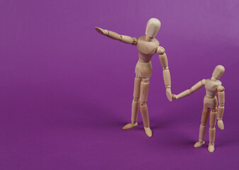 Parenthood. Two puppets hold hands on a purple background