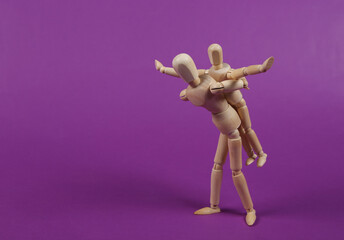 Two puppets impersonating a guardian and a child fooling around against purple background. Spending...