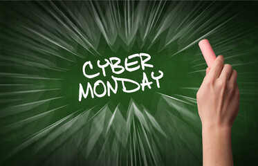 Hand drawing CYBER MONDAY inscription with white chalk on blackboard, online shopping concept