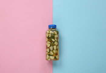Detox drink, cucumber lemonade bottle on blue pink background. Top view. Flat lay. Minimalism