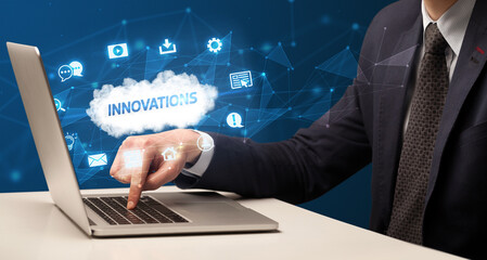 Businessman working on laptop with INNOVATIONS inscription, modern technology concept