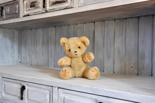 Vintage teddy bear on old fashioned shelf
