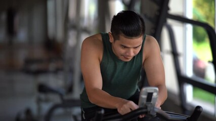 footage of sport man riding a bike at the gym, sport concept