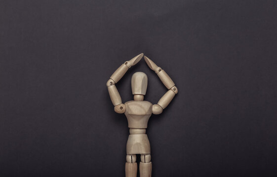 Protected wooden mannequin on gray background