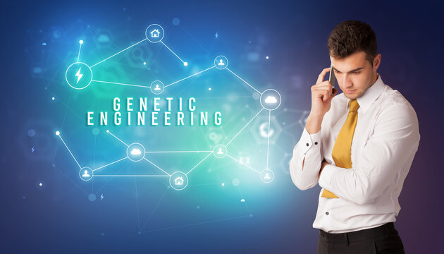 Businessman in front of cloud service icons with GENETIC ENGINEERING inscription, modern technology concept