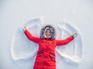 Snow angel made by a happy woman in the snow.