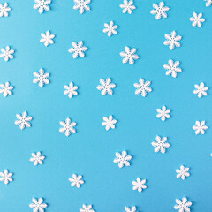 Pattern made of snowflakes on a blue background.Minimal Flat Lay.