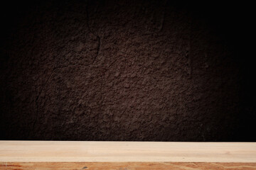 image of a wooden table on an abstract dark background with light in the center