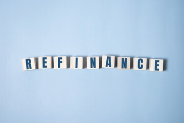 focus on wooden blocks with letters Refinance text. Concept image