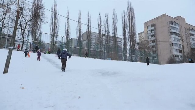 Fun on a winter hill with snow. Slow motion 01.10.2020 Ukraine, Kiev. HD