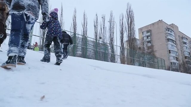 Guys climb a snow slide. Slow motion 01.10.2020 Ukraine, Kiev. HD
