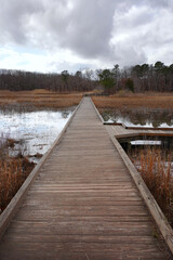 Long wooden bridge over flooded ground waters