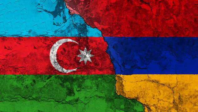 Concept of the Conflict between Armenia and Azerbaijan with painted Flags on a Wall and a Crack between them