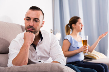 Fototapeta premium Husband is upset because his wife is watching football at home.