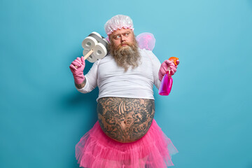 Photo of thoughtful bearded man dressed like fairy works in cleaning service thinks what to clean...