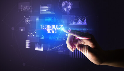 Hand touching TECHNOLOGY NEWS inscription, new business technology concept