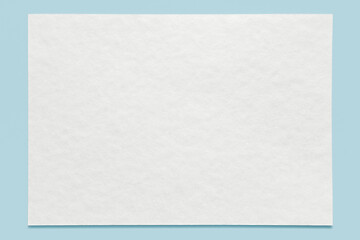 Blank watercolor paper, isolated on light blue