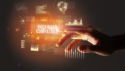 Hand touching BACKWARD COMPATIBLE inscription, new business technology concept